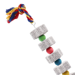 Jouet Oooct étoile jaune, pierre calcaire, cloche et perles pour stimulation ludique.