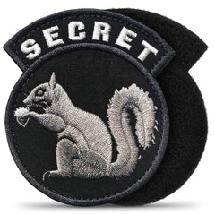Insigne secret écureuil Tesorrio sur veste tactique, fixation facile au velcro.