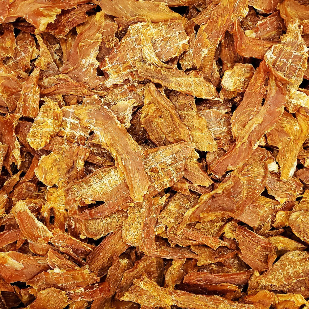 American Paws friandises de poulet séché, réaction enthousiaste du chien à l'ouverture du sachet.