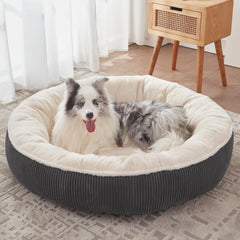 BedStill Donut pour chien XL sur sol gris foncé, confort enveloppant.