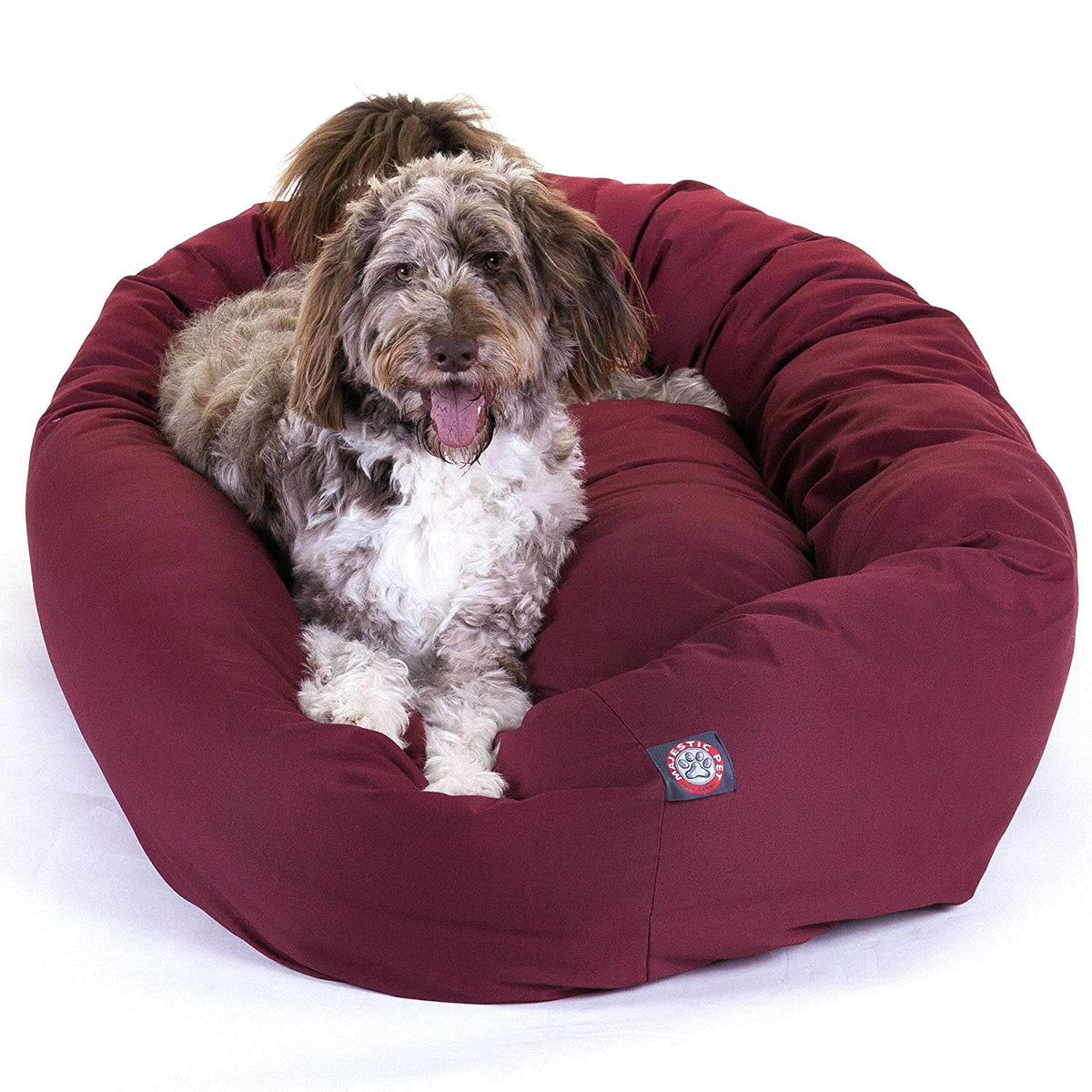 Lit bagel Majestic Pet 52'' enveloppant le chien de douceur et contact cocooning.