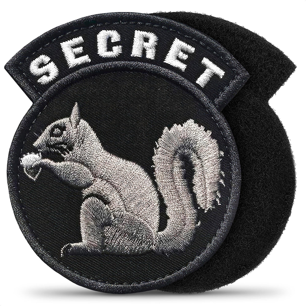 Insigne secret écureuil Tesorrio sur veste tactique, fixation facile au velcro.