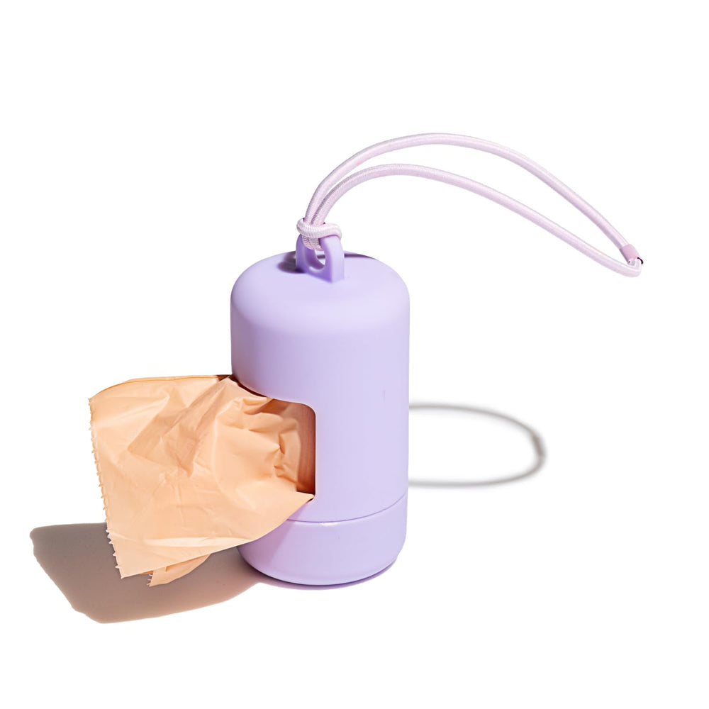 Porte-sacs crottes Wild One lilas fixé à la laisse, pratique et propre.
